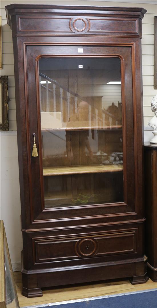 A 19th century French plum pudding mahogany bookcase, enclosed by a single glazed door W.115cm